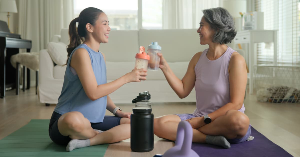 a younger and older woman enjoying a protein shake post workout