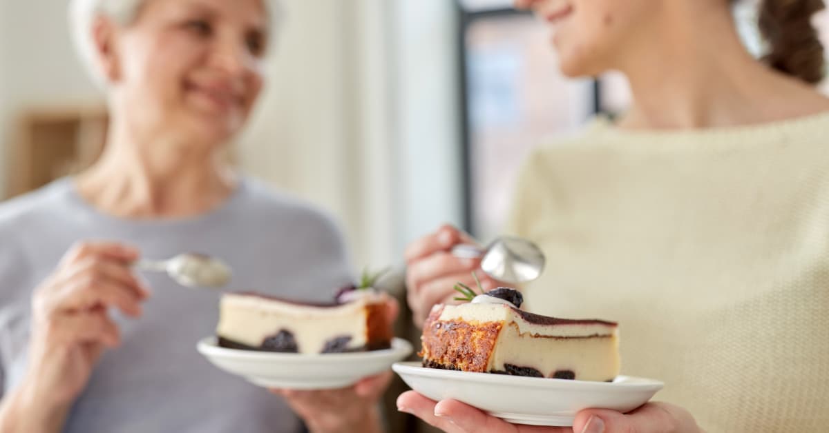 older woman and younger woman enjoying a sweet treat 