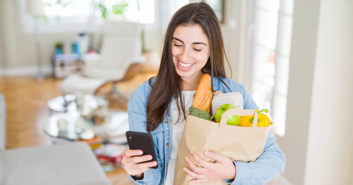 Woman using delivery service to get healthy groceries at home