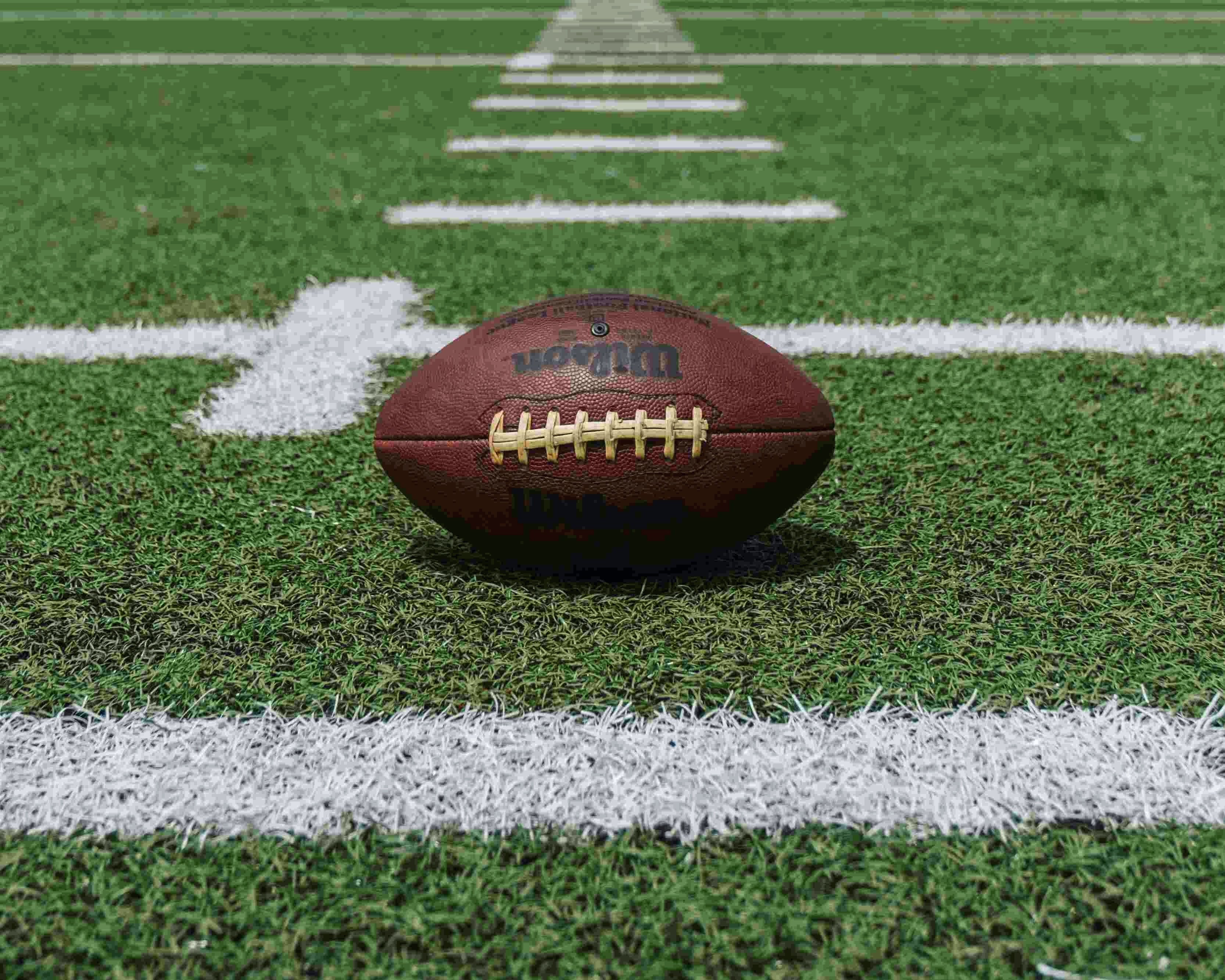 American football on an outdoor turf